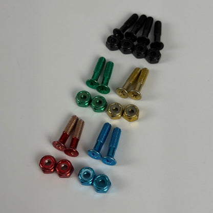 Colored skate bolts and nuts laid out by color: black, green, gold, red, and blue