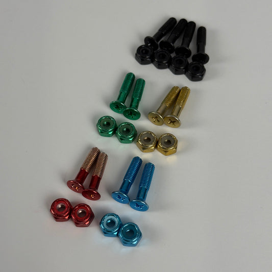 Colored skate bolts and nuts laid out by color: black, green, gold, red, and blue